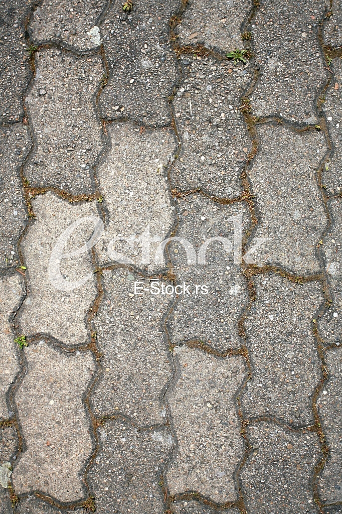 The fragment of a pavement footpath Paving stone with holes