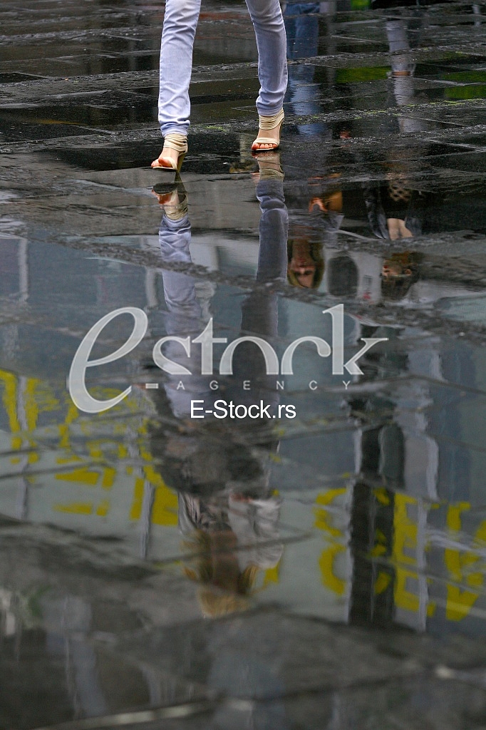 woman reflection in the water after the rain woman reflection in the water after the rain