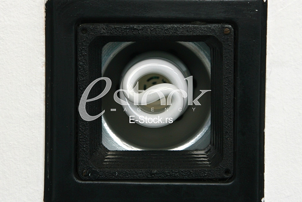 Energy saving fluorescent light bulb in the chandelier on the ceiling Energy saving fluorescent light bulb in the chandelier on the ceiling