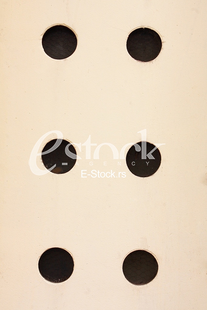 yellow wall with black holes