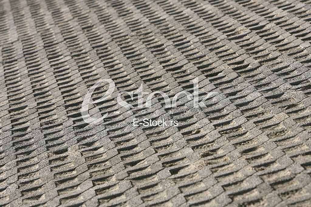 The fragment of a pavement footpath Paving stone with holes
