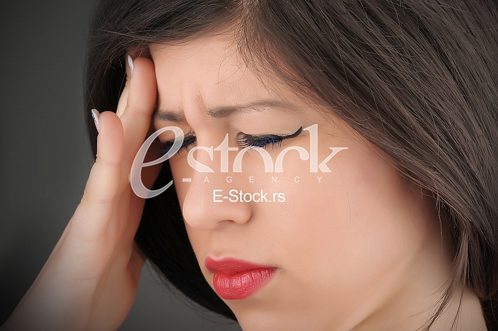 woman in pain holding her head woman in pain holding her head