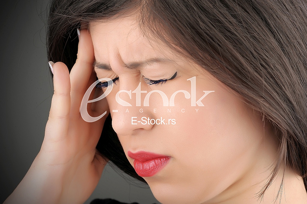 woman in pain holding her head woman in pain holding her head