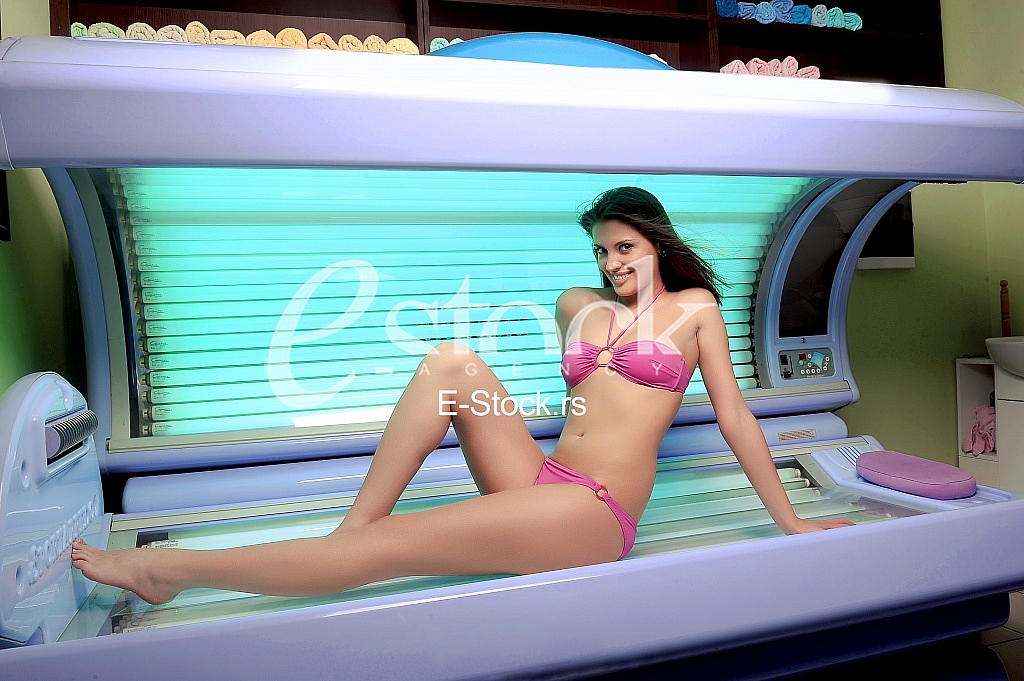 Young woman posing on tanning bed Young woman posing on tanning bed