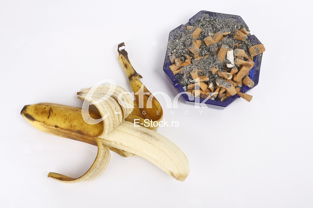 a lot of cigarettes in the ashtray and banana
