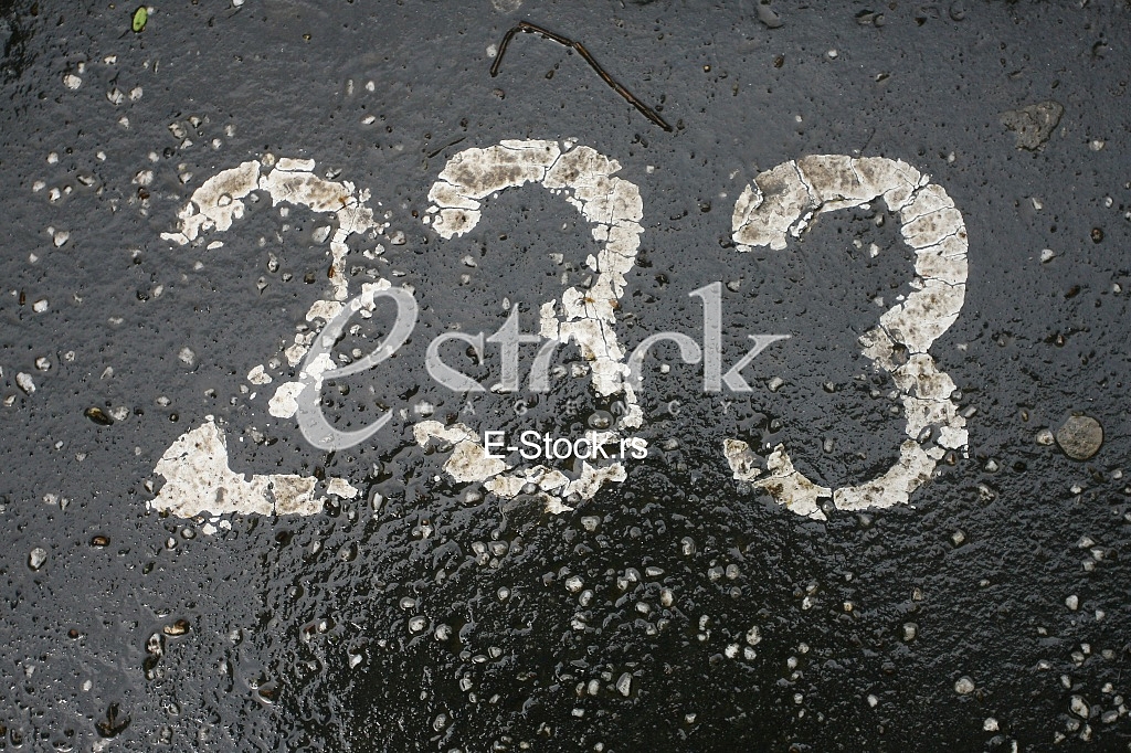 parking number painted in white on asphalt 233
