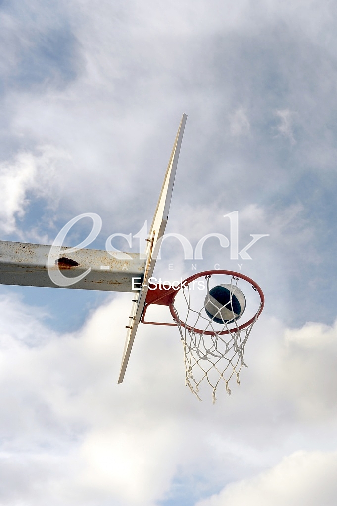 basket ball board under blue sky with white clouds and ball