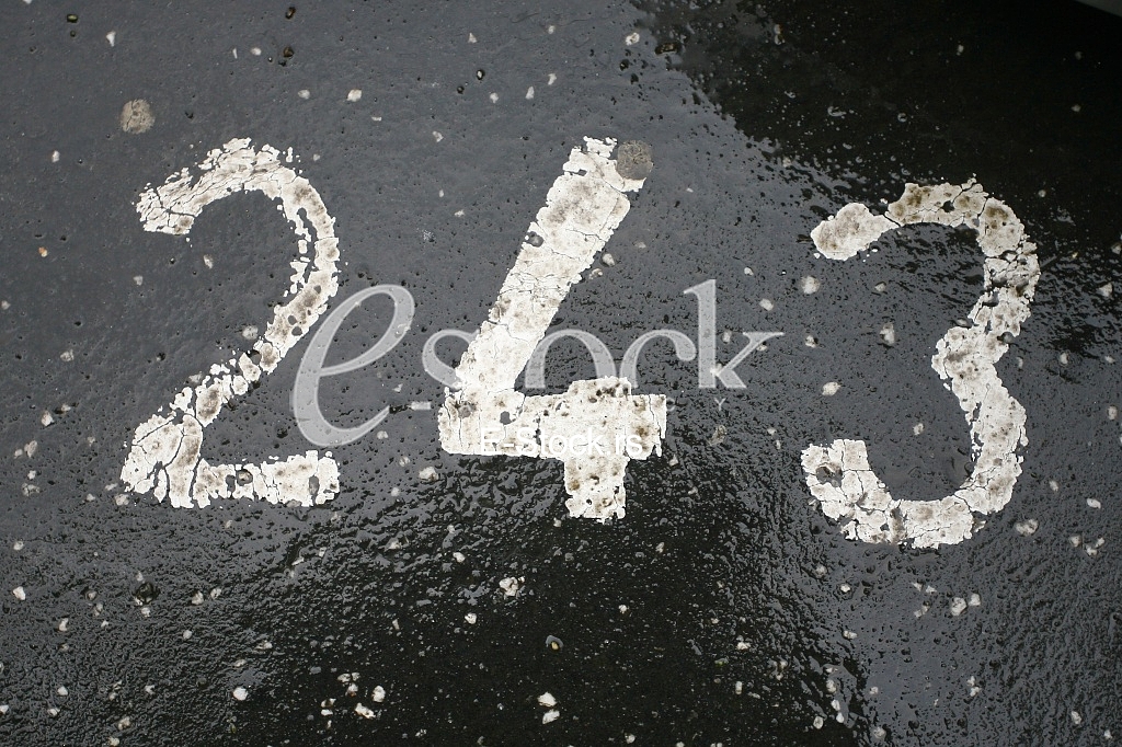 parking number painted in white on asphalt 243