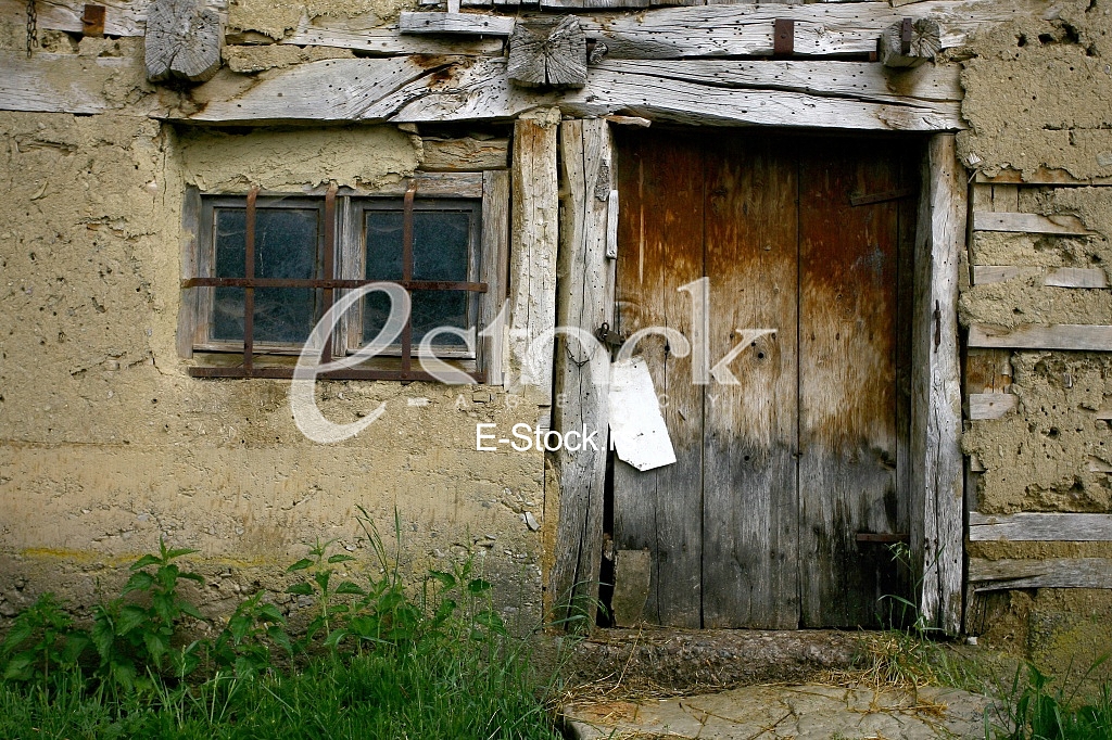 old door and window of abandoned tenement house in the village