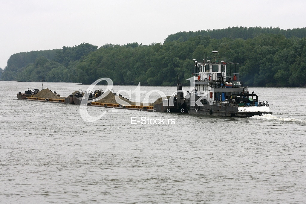 push boat Barge pushed by towboat on the river freighter ship with sand