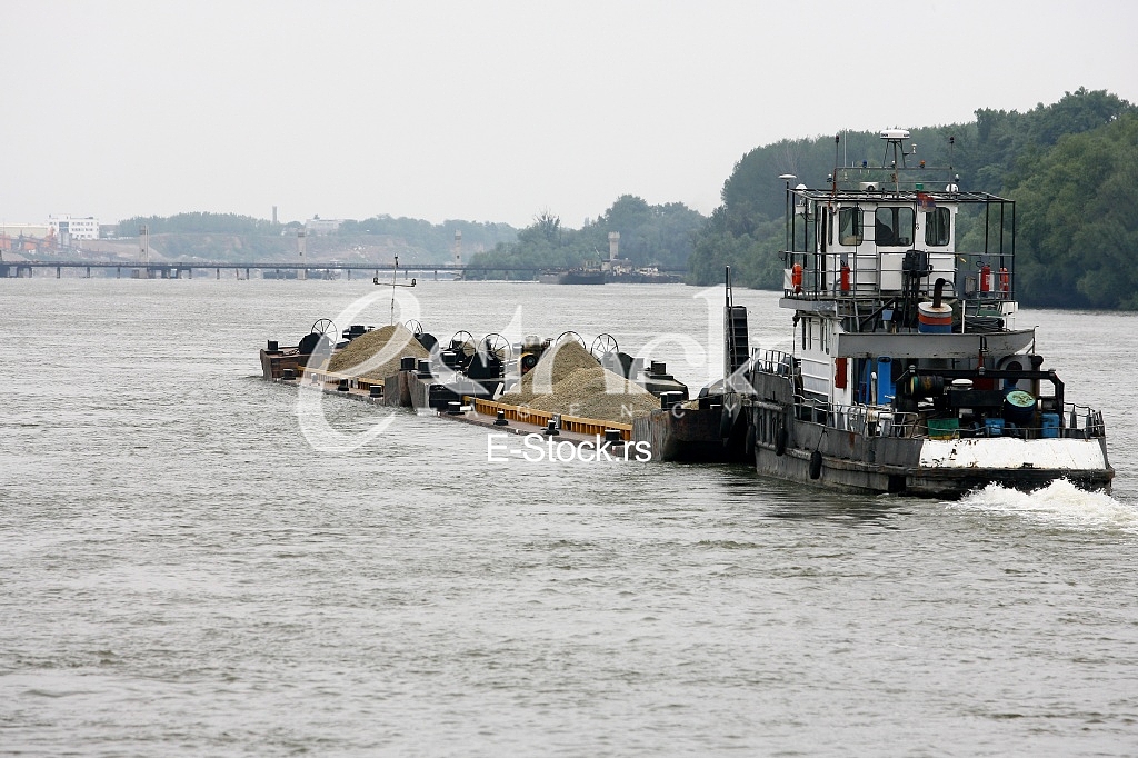 push boat Barge pushed by towboat on the river freighter ship with sand