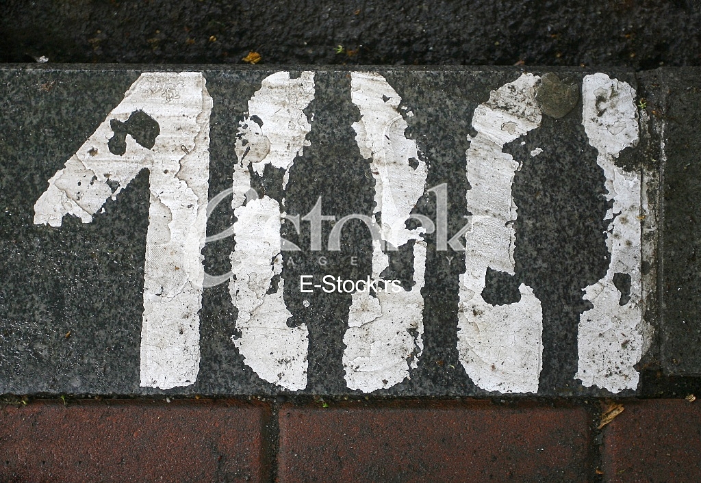 parking number painted in white on asphalt 100