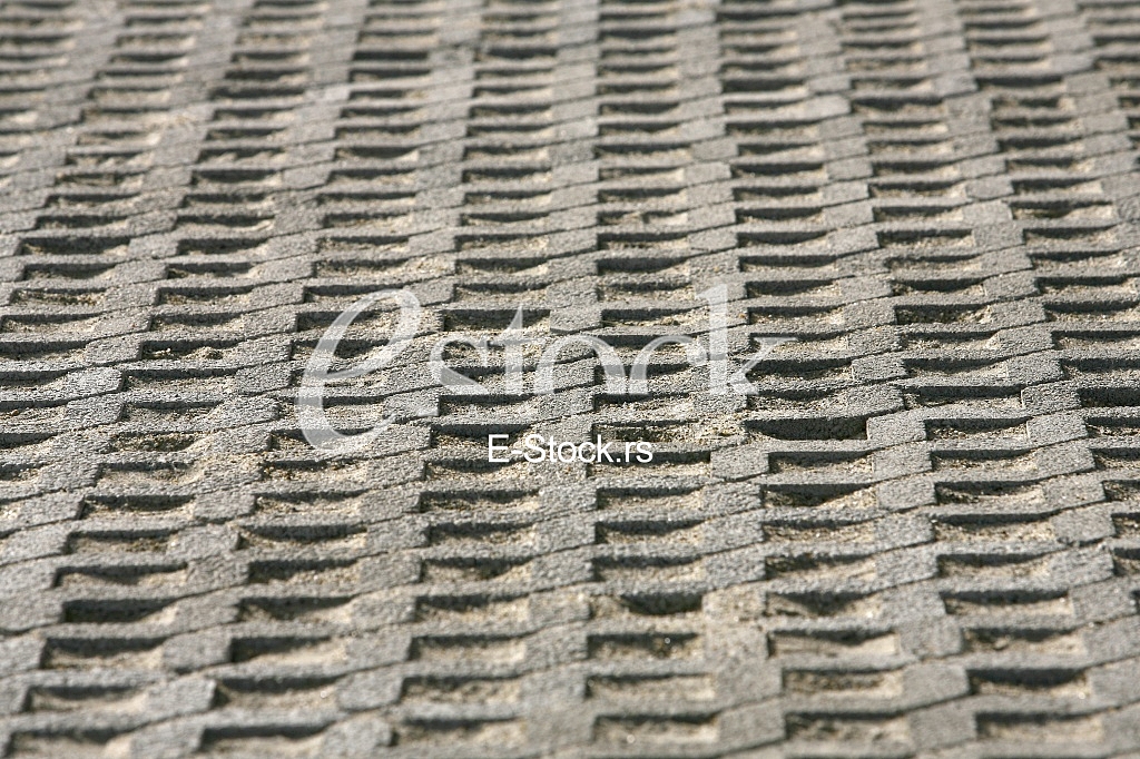 The fragment of a pavement footpath Paving stone with holes
