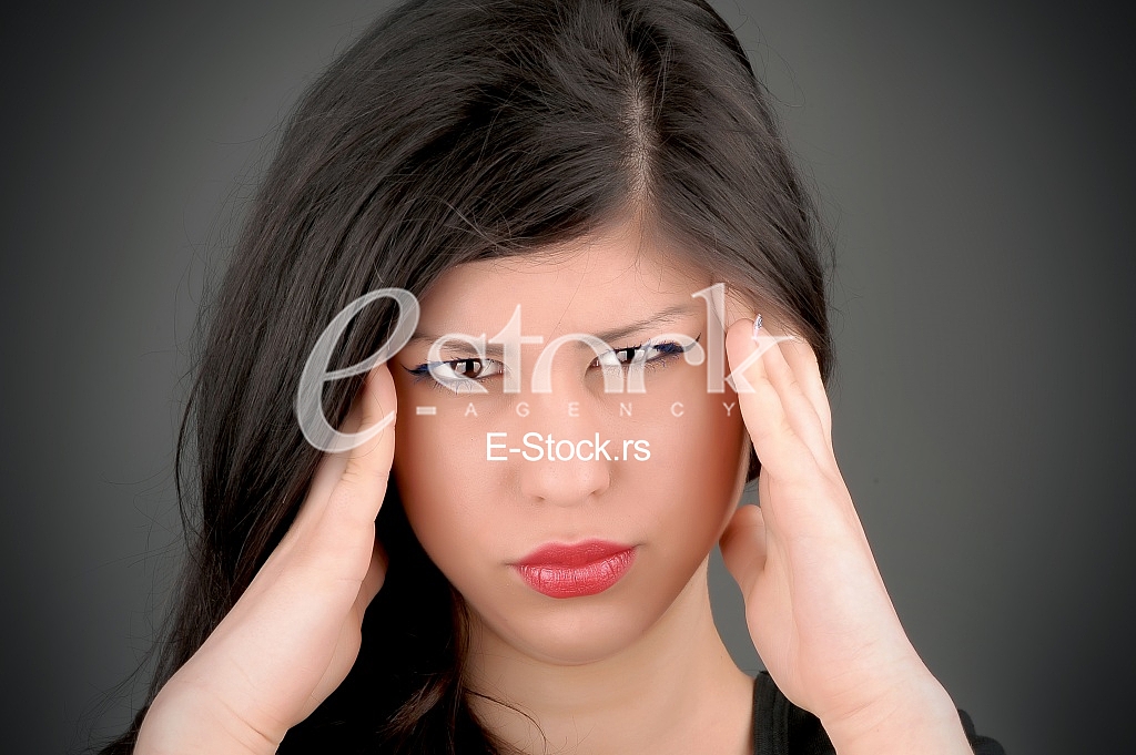 woman in pain holding her head