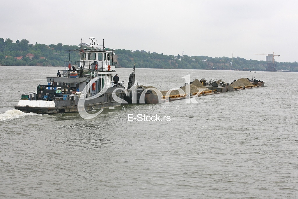 push boat Barge pushed by towboat on the river freighter ship with sand