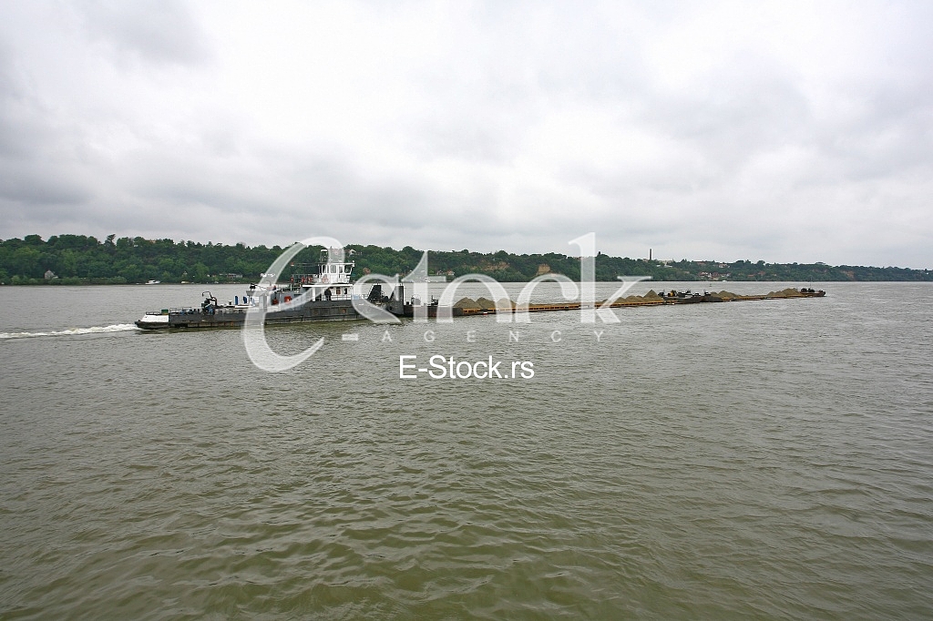 push boat Barge pushed by towboat on the river freighter ship with sand