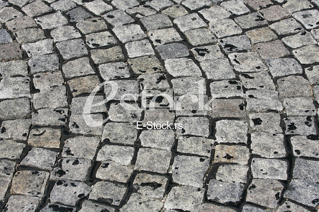 small cobblestone sidewalk made of cubic stones structured background