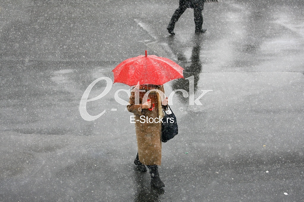 Girl with umbrella during snow storm