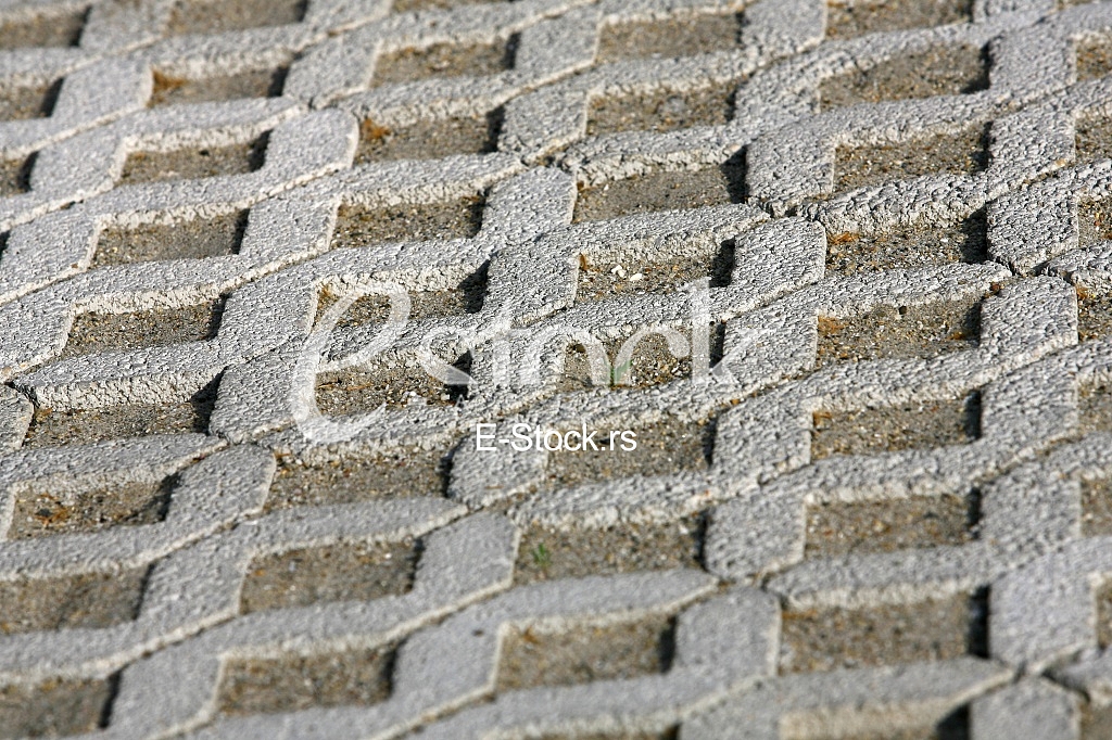 The fragment of a pavement footpath Paving stone with holes
