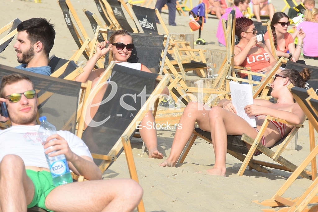 Young people on the beach strand enjoy the Spring sunny day