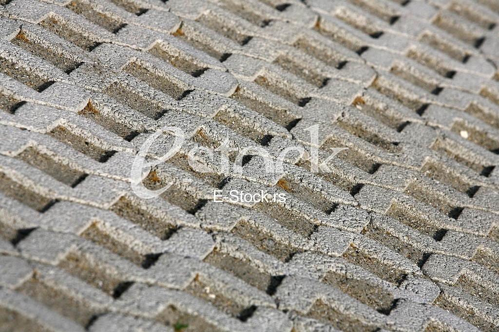 The fragment of a pavement footpath Paving stone with holes
