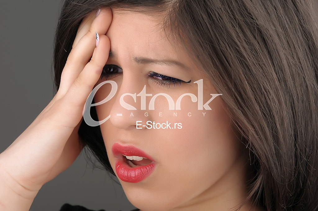 woman in pain holding her head