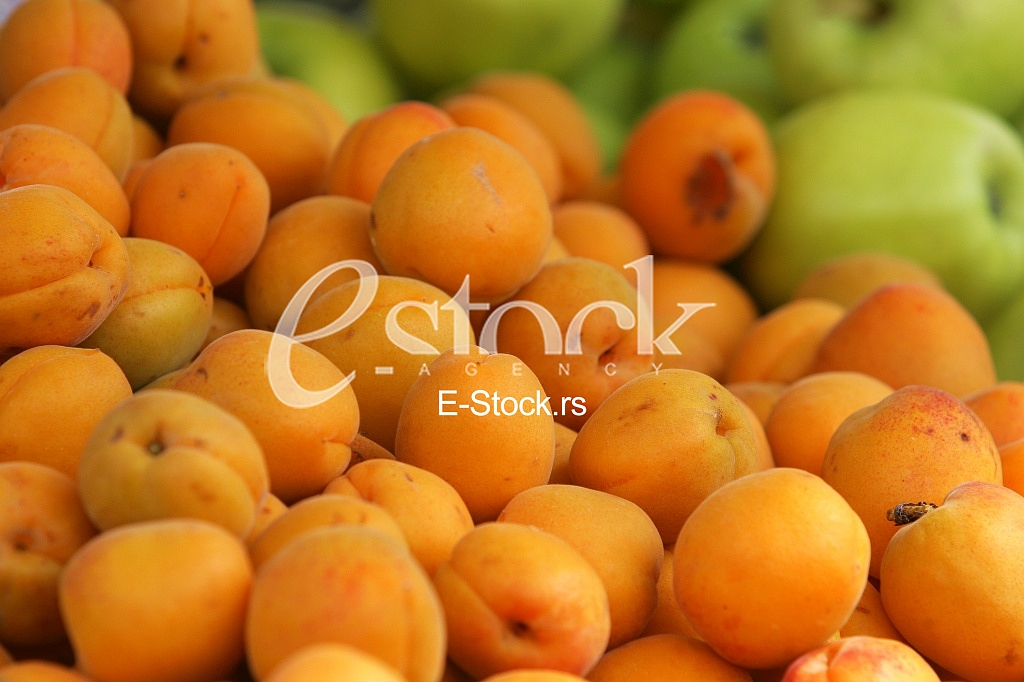 Fresh natural apricot and apples to background on the street market