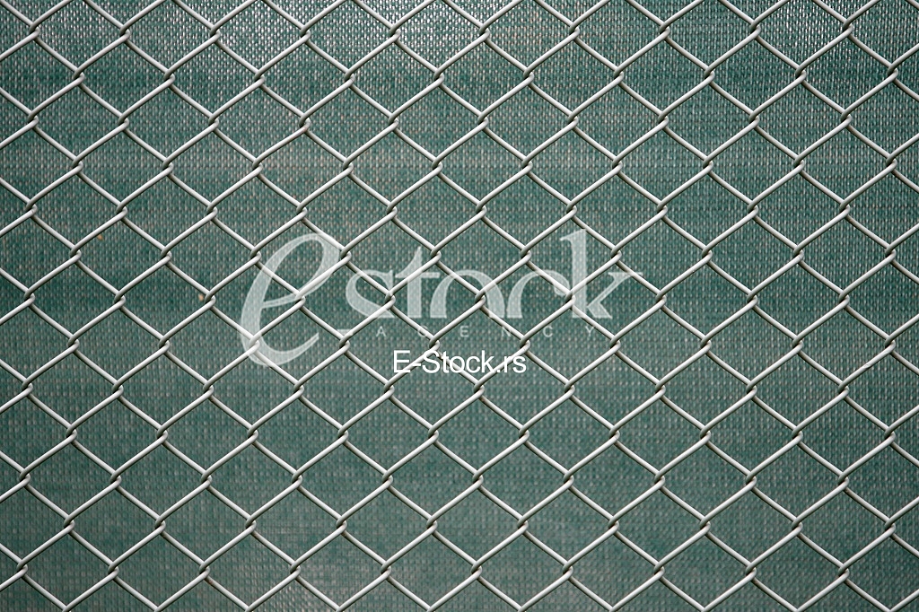 Metal wire fence on green for background