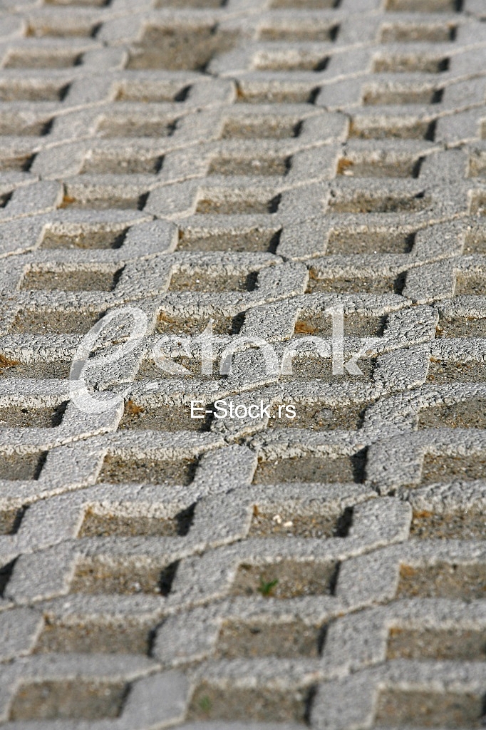 The fragment of a pavement footpath Paving stone with holes
