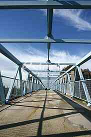 a metal bridge in blue, gangway pedestrian footbridges