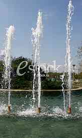 Fountain drops of pure brilliant water against a blue clear sky