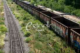 Cargo train platform railway tracks in a rural scene, Empty railway containers for transportation covered with a rust