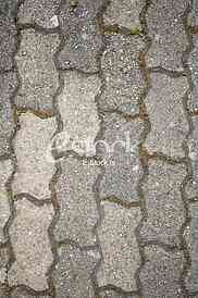 The fragment of a pavement footpath Paving stone with holes