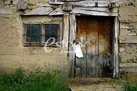 old door and window of abandoned tenement house in the village