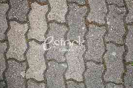 The fragment of a pavement footpath Paving stone with holes