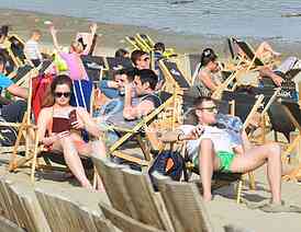 Young people on the beach Strand enjoys the Spring sunny day
