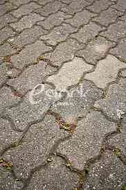 The fragment of a pavement footpath Paving stone with holes