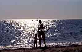Woman with little boy at the sunset