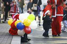 People in Santa Claus costumes take part in the race