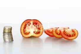 Tomato vegetables pile isolated on white background cutout with coins