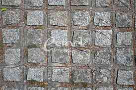 The fragment of a pavement footpath Paving stone with holes