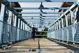 a metal bridge in blue, gangway pedestrian footbridges