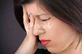 woman in pain holding her head