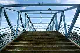 a metal bridge in blue, gangway pedestrian footbridges