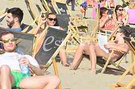Young people on the beach strand enjoy the Spring sunny day