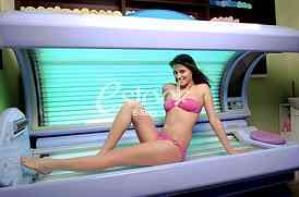Young woman posing on tanning bed