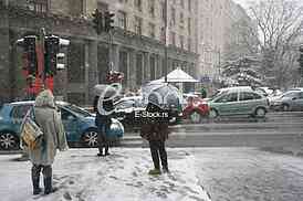 People with umbrella during snow storm car with pedestrian