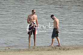 Young people on the beach strand enjoy the Spring sunny day