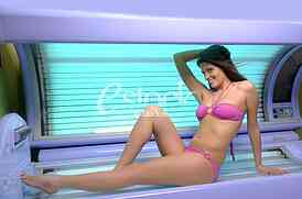 Young woman posing on tanning bed