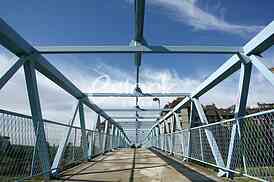 a metal bridge in blue, gangway pedestrian footbridges